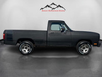 Step into the muscular allure of the 1991 Dodge D150 & W150 BASE, dressed in a commanding black hue.... (image 5)