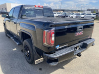 Poised for performance and utility, the 2018 GMC Sierra 1500 SLT stands proudly with a sleek Onyx Bl... (image 5)