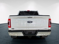 The 2021 Ford F-150 Lariat, clad in a stunning white coat and equipped with a robust 4x4 drivetrain,... (image 6)