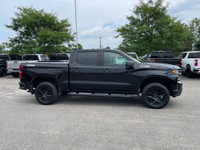 The 2022 Chevrolet Silverado 1500 LTD Custom Trail Boss in an adventurous black finish, powers throu... (image 6)