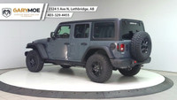The 2025 Jeep Wrangler 4xe 4-Door Willys, in a striking gray, is a new adventure-ready 4x4 SUV that... (image 2)