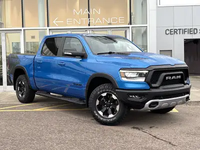 The 2022 Ram 1500 Rebel in Hydro Blue Pearl stands out with bold styling and off-road capability. Eq...