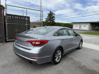 This 2016 Hyundai Sonata is a reliable sedan with a sleek gray exterior and a spacious interior in a... (image 4)