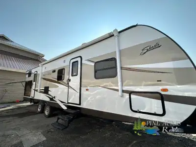 Step into the Revere 32DS travel trailer from Shasta to find a private front bedroom to your right....