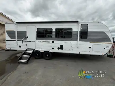 This is a travel trailer with a variety of features, including exterior speakers, luxury vinyl floor...