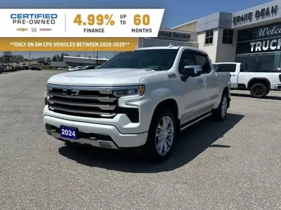 The Chevrolet Silverado 1500 High Country in pristine white with a robust 4×4 drivetrain ensures exc...
