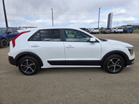 Step into the future of efficient driving with the 2025 Kia Niro Plug-In Hybrid LXa sleek crossover... (image 2)