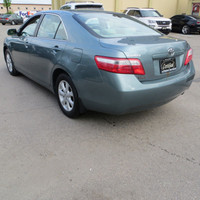 This 2007 Toyota Camry is a reliable sedan with a sleek green exterior and a comfortable gray interi... (image 5)