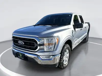 Step into the world of power and versatility with the silver Ford F-150 XLT, exclusively crafted to...