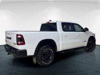 The 2022 Ram 1500 Rebel 4x4 Crew Cab 57 Box in stunning white lets you command every road with confi... (image 1)