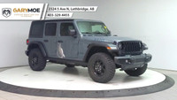 The 2025 Jeep Wrangler 4xe 4-Door Willys, in a striking gray, is a new adventure-ready 4x4 SUV that... (image 6)