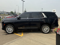 The 2021 Cadillac Escalade Luxury in Dark Moon Blue Metallic makes a bold statement with its 22-inch... (image 4)