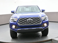 Introducing the sleek blue 2023 Toyota Tacoma. This truck is packed with various features to make yo... (image 1)