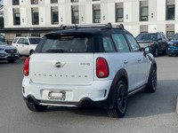 This 2016 Mini Cooper Countryman has a White exterior with Black Stripes and Black seats with seatin... (image 6)