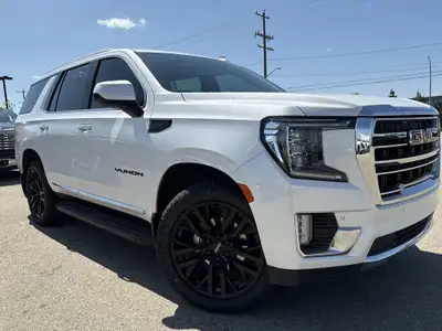 Roll out in style with this elegant and robust 2023 GMC Yukon SLT, showcasing a luxurious White Fros...
