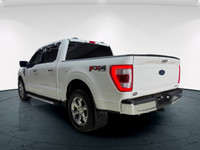 The 2021 Ford F-150 Lariat, clad in a stunning white coat and equipped with a robust 4x4 drivetrain,... (image 7)