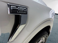 The 2021 Ford F-150 Lariat, clad in a stunning white coat and equipped with a robust 4x4 drivetrain,... (image 3)