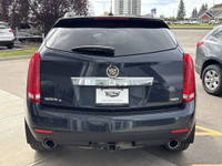The 2015 Cadillac SRX Premium Collection, shown in Sapphire Blue Metallic, delivers confident perfor... (image 6)