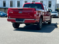 This 2015 Ford F-150 XLT has a Ruby Red Metallic exterior and Black Sport Interior with seating for... (image 7)