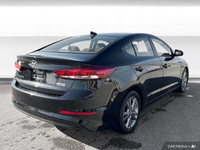 The 2017 Hyundai Elantra in Space Black Pearl features heated front seats, a heated leather steering... (image 5)