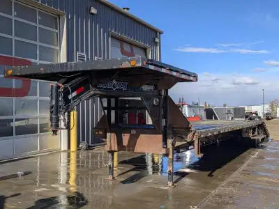 The 2013 Loadmax Highboy Deckover Gooseneck Trailer is designed to handle heavy-duty loads with exce...