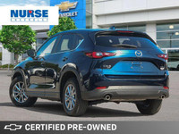 This 2022 Mazda CX-5 GS SUV boasts a sleek blue exterior and a sophisticated black leatherette inter... (image 2)