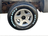 Step into the muscular allure of the 1991 Dodge D150 & W150 BASE, dressed in a commanding black hue.... (image 9)