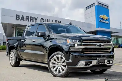 Experience the power and elegance of the black Chevrolet Silverado 1500 High Country, equipped with...
