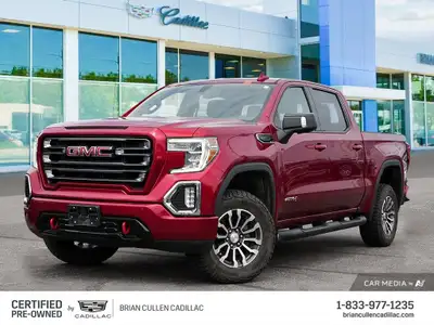 The 2021 GMC Sierra 1500 AT4 in vibrant red stands ready to take on any terrain with its 44 drive tr...