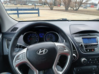 Drive with confidence in this 2011 Hyundai Tucson! With its spacious interior, smooth handling, and... (image 9)