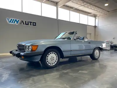Presenting the 1987 Mercedes Benz 560SL, a rare and coveted classic convertible that exemplifies lux...