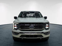 The 2021 Ford F-150 Lariat, clad in a stunning white coat and equipped with a robust 4x4 drivetrain,... (image 2)