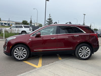 The 2017 Cadillac XT5 Platinum in Red Passion Tintcoat delivers all-wheel drive performance powered... (image 4)