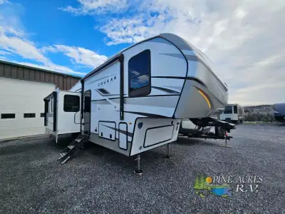 Keystone Cougar Half-Ton fifth wheel 29RLI highlights: Kitchen Island Opposing Slides Private Bedroo...