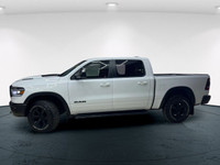 The 2022 Ram 1500 Rebel 4x4 Crew Cab 57 Box in stunning white lets you command every road with confi... (image 3)