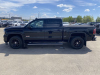 Poised for performance and utility, the 2018 GMC Sierra 1500 SLT stands proudly with a sleek Onyx Bl... (image 4)