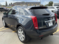 The 2015 Cadillac SRX Premium Collection, shown in Sapphire Blue Metallic, delivers confident perfor... (image 5)