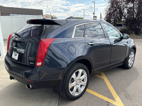 The 2015 Cadillac SRX Premium Collection, shown in Sapphire Blue Metallic, delivers confident perfor... (image 7)
