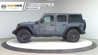 The 2025 Jeep Wrangler 4xe 4-Door Willys, in a striking gray, is a new adventure-ready 4x4 SUV that... (image 1)