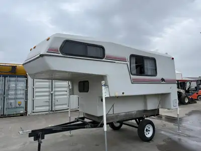 This 1990 Kodiak Truck Camper came into our lot as a bank repo. Needs a bit of TCL and is overall in...
