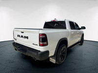 The 2022 Ram 1500 Rebel 4x4 Crew Cab 57 Box in stunning white lets you command every road with confi... (image 6)