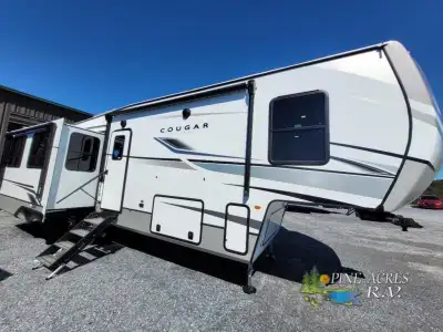 This fifth wheel weighs 10,679lbs and features 3 slides, secure stance step, front king bedroom with...