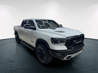 The 2022 Ram 1500 Rebel 4x4 Crew Cab 57 Box in stunning white lets you command every road with confi... (image 9)