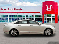 Experience effortless elegance with this 2016 Lincoln MKZ. Boasting a sleek silver exterior and a me... (image 6)