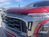 The 2025 Chevrolet Equinox ACTIV, dressed in a bold Radiant Red exterior with a distinctive Maple Su... (image 2)