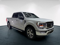 The 2021 Ford F-150 Lariat, clad in a stunning white coat and equipped with a robust 4x4 drivetrain,... (image 4)