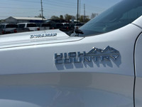 The Chevrolet Silverado 1500 High Country in pristine white with a robust 4×4 drivetrain ensures exc... (image 5)