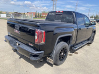 Poised for performance and utility, the 2018 GMC Sierra 1500 SLT stands proudly with a sleek Onyx Bl... (image 7)