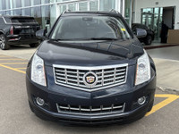 The 2015 Cadillac SRX Premium Collection, shown in Sapphire Blue Metallic, delivers confident perfor... (image 1)