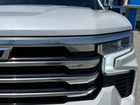 The Chevrolet Silverado 1500 High Country in pristine white with a robust 4×4 drivetrain ensures exc... (image 2)